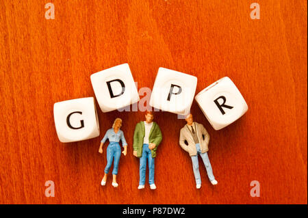 miniature figurines and dice spelling the word GDPR - General Data Protection Regulation Stock Photo