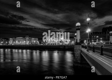 night city view of old town and  kursaal bridge shot from Gros, above urumea river. Stock Photo