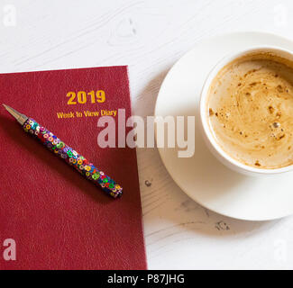 A 2019 desk dairy with a cup of coffee alongside. Stock Photo