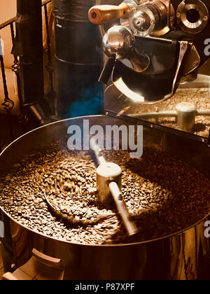 Freshly Roasted Aromatic Coffee Beans in a Coffee Roasting Machine. Organic Food. Stock Photo