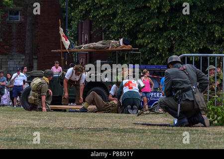 2nd world war re-enactors depicting a medical retrieval from the battlefield in Trowbridge park during the Armed forces celebration weekend Stock Photo