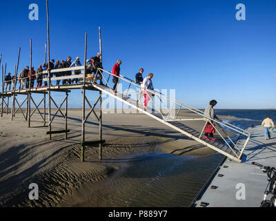 Mensen lopen over oude steiger richting veerpont; People walking on old landing stage to ferry Stock Photo