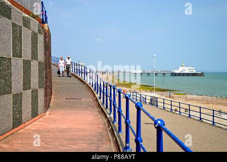 The seafront at Eastbourne on a hot summers day with the pier and beach in the background, East Sussex England UK Stock Photo