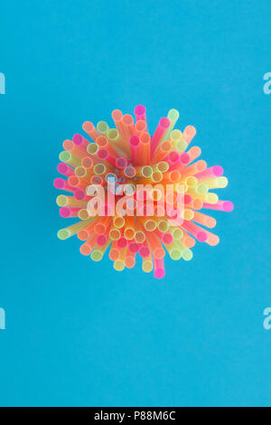 Creative view of drinking straws(neon colors) party on blue background. Top view. Stock Photo