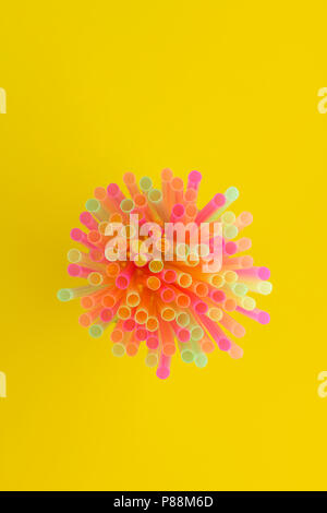 Creative view of drinking straws(neon colors) party on yellow background. Top view. Stock Photo