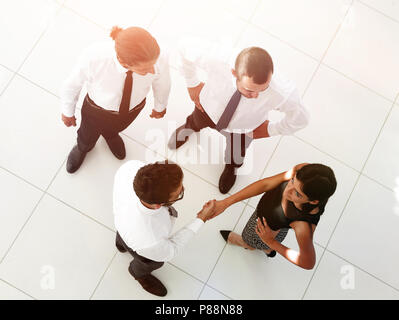 view from the top.welcome colleagues shaking hands in office Stock Photo