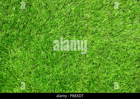 Bright green artificial grass in a football field. This requires a lot of artificial grass - green grass texture or green grass background for footbal Stock Photo