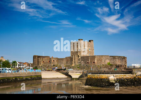 UK, Northern Ireland, Co Antrim, Carrickfergus, Norman Castle from across the harbour at low tide Stock Photo