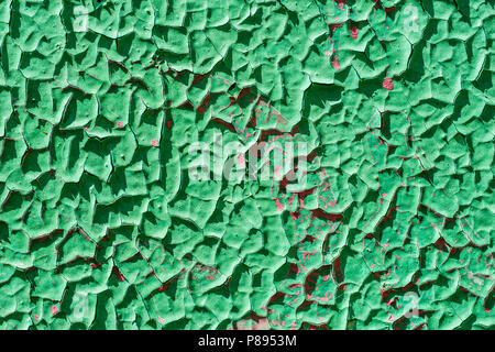 Texture of old, peeled off, broken, cracked green paint on a metal surface. Grunge, rough texture or background. Stock Photo