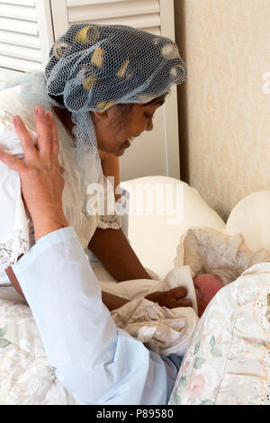 Mature woman smothering her husband in bed after too much snoring Stock Photo
