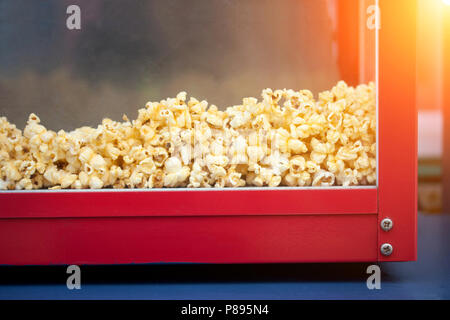 A pile of popcorn in a popcorn maker - popcorn for sale in stores. Stock Photo