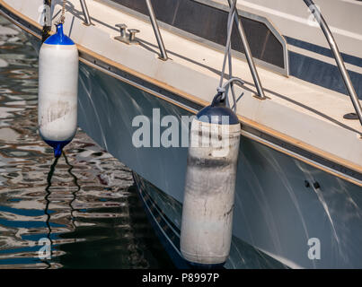 buoy hanging outside the hull of the boat, boat equipment, safety at sea Stock Photo