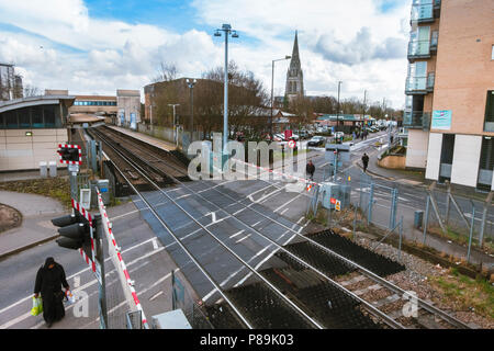 FELTHAM, UK - March 16 2018: Feltham railway station with view towards the tower of the now-demolished St Catherine's Church. Feltham, UK Stock Photo