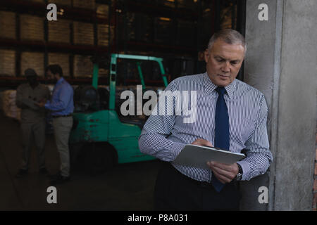 Male manager writing on a clipboard Stock Photo