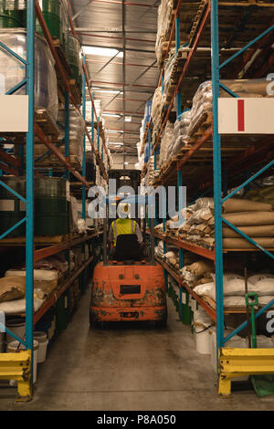Male worker driving forklift Stock Photo