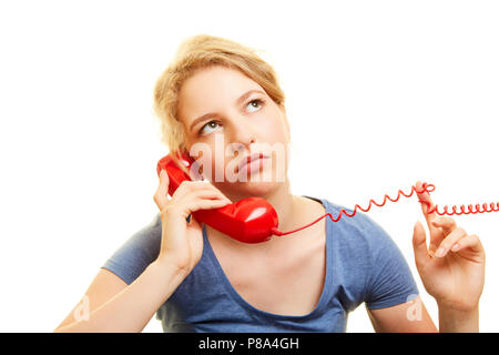 Young woman hears frustrated background music in a telephone waiting loop Stock Photo