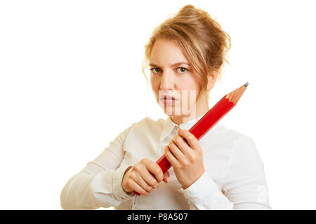 Business woman defensively holds a big red pencil in both hands Stock Photo