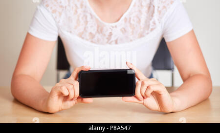 Female hands hold smartphone for responsive design mockup Stock Photo