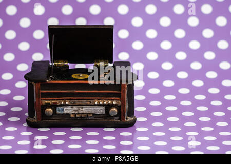 Decorative retro record player on purple background Stock Photo