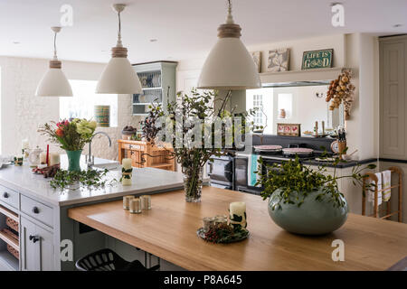 Three large pendant shades hang above wooden worktop in Regency kitchen Stock Photo