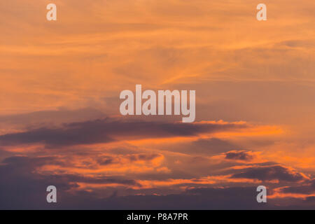 the divine beauty of the sky during sunset and the sun peeping out from behind the clouds . For your design Stock Photo