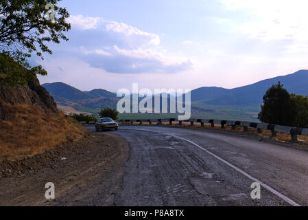 a steep twist of the wet asphalt road between the lifeless and unsightly mountains in the south . For your design Stock Photo