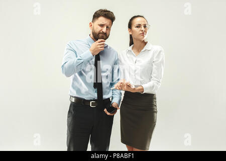 Angry boss. Man and his secretary standing at office or studio Stock Photo