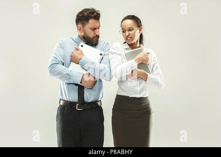 Angry boss. Man and his secretary standing at office or studio Stock Photo