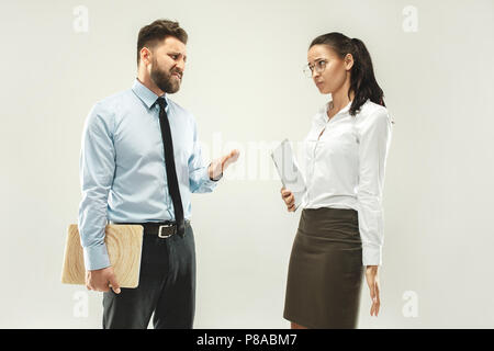 Angry boss. Man and his secretary standing at office or studio Stock Photo