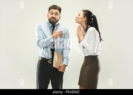 Angry boss. Man and his secretary standing at office or studio Stock Photo