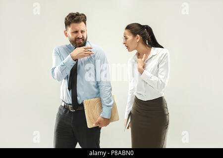 Angry boss. Man and his secretary standing at office or studio Stock Photo