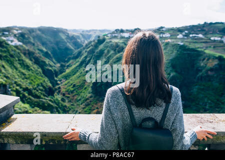 Back view of traveler woman enjoying beautiful green canyon on Gran Canaria, Canary islands, Spain. Tourism concept Stock Photo