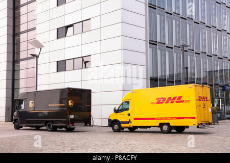 DHL parcel service and UPS parcel service cars in front of Crane House South at Rheinau harbor, Cologne, Germany.  DHL und UPS Fahrzeuge vor dem Kranh Stock Photo