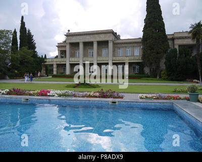 clear water pool in a park with a shaved lawn and flower beds in front of the house . For your design Stock Photo