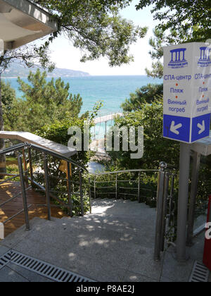 A staircase leading to the sea and an indicator near it, indicating where the spa is located, the beaches of the wine cellar . For your design Stock Photo