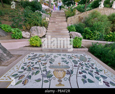 Beautiful laid out of small tiles beautiful picture with flowers and birds playground in the park in front of the steps going up. . For your design Stock Photo