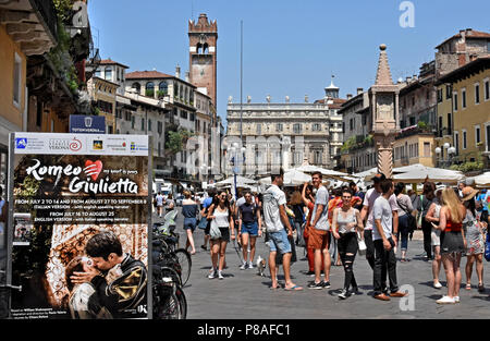 Market stalls in front of the Torre dei Lamberti in the Piazza delle Erbe, Verona ,Veneto, Italy, Italian. ( William Shakespeare's Romeo and Juliet, first published in 1597, is considered to be the first romantic tragedy ever written. ) Stock Photo