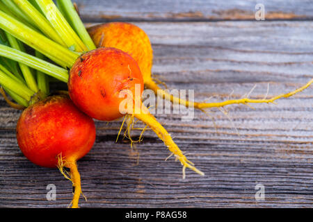 golden beets freshly harvested  raw on rustic wood background Stock Photo