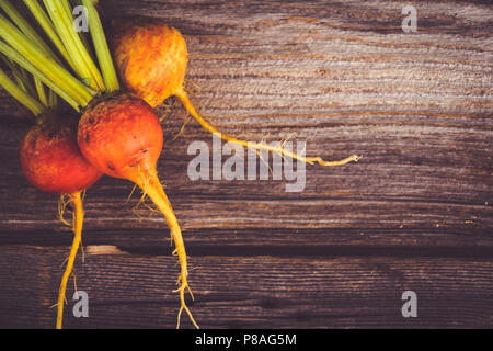 golden beets freshly harvested  raw on rustic wood background Stock Photo