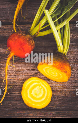 golden beets freshly harvested  raw on rustic wood background Stock Photo