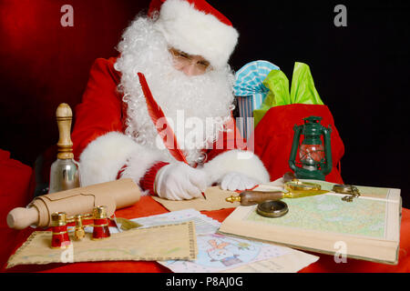 Portrait of Santa Claus answering Christmas letters. Santa Claus at his office, writing letter Stock Photo