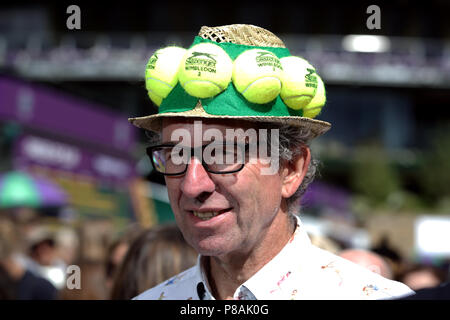 A spectator wearing a tennis ball themed hat on day eight of the Wimbledon Championships at the All England Lawn Tennis and Croquet Club, Wimbledon. PRESS ASSOCIATION Photo. Picture date: Tuesday July 10, 2018. See PA story TENNIS Wimbledon. Photo credit should read: John Walton/PA Wire. RESTRICTIONS: Editorial use only. No commercial use without prior written consent of the AELTC. Still image use only - no moving images to emulate broadcast. No superimposing or removal of sponsor/ad logos. Call +44 (0)1158 447447 for further information. Stock Photo