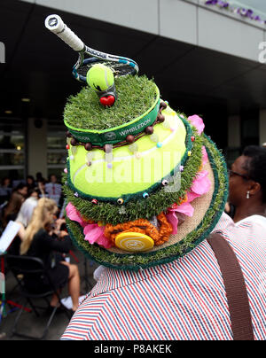 A spectator wearing a tennis themed hat on day eight of the Wimbledon Championships at the All England Lawn tennis and Croquet Club, Wimbledon. Stock Photo