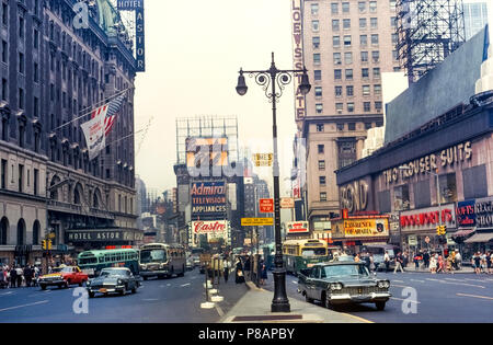 The famed Times Square in New York City, New York, USA, was photographed during the daytime in 1963 prior to its rebirth decades later as the tourist entertainment center that it is today. High-rise office buildings have replaced the 1904 Hotel Astor (left) and 1921 Lowe’s State Theater (right) while the vintage stores have become home to brand-name retailers, restaurants, and family attractions. Flashy digital and neon signs and billboards dominate the lively pedestrian scene that now draws an estimated 50 million visitors a year to this part of Midtown Manhattan. Historical photograph. Stock Photo