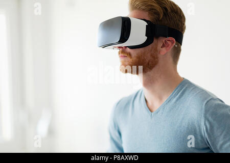Man wearing virtual reality headset at home Stock Photo