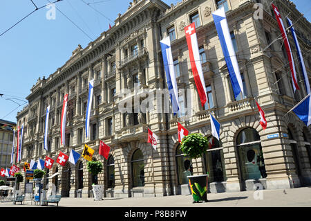 Switzerland: Credit Suisse Headquarter at Paradeplatz in Zürich-City decorated at national day with flags of all swiss cantons Stock Photo