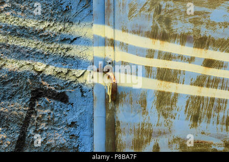 Textured spray painted wall and rusty metal abstract background. Stock Photo