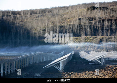 Mist rising from solar panels in Varen  South-West France The solar power station was built in a disused Lafarge quarry near Lexos. Stock Photo