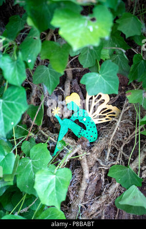 Cut out figure of a green fairy sitting in a tree Stock Photo