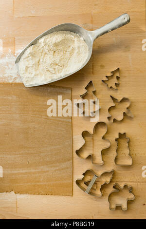 ginger bread dough and metallic cookie cutter in different shape for backing Christmas cookies Stock Photo